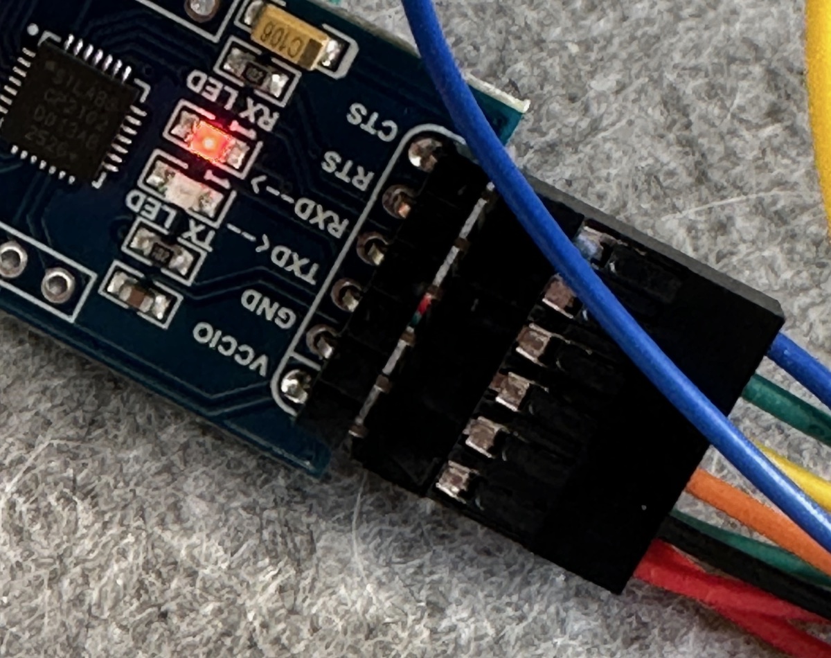 CP2102 adapter header with jumper wires connected to GND, TX, and RX